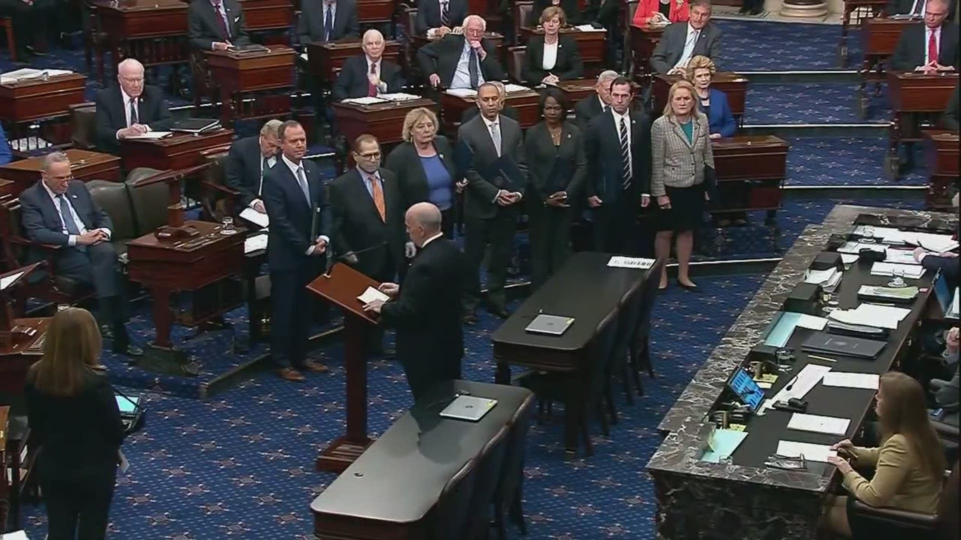 The solemn procession began with House Impeachment Managers making their way into the Senate Chamber. The House prosecutors read the charges against President Trump.