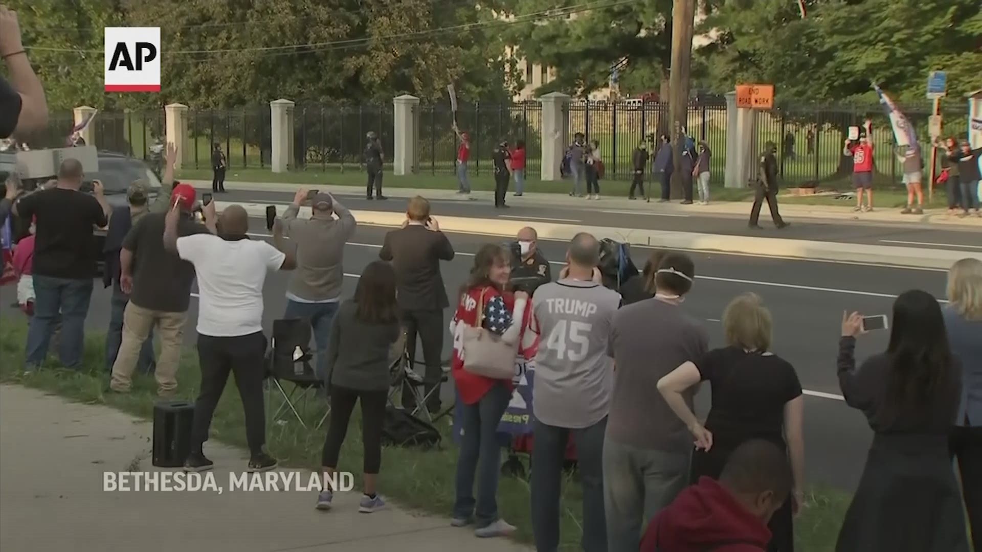 Trump briefly left the hospital Sunday in his car to wave to supporters outside, shortly after he promised them 'a surprise' in a video posted on social media.