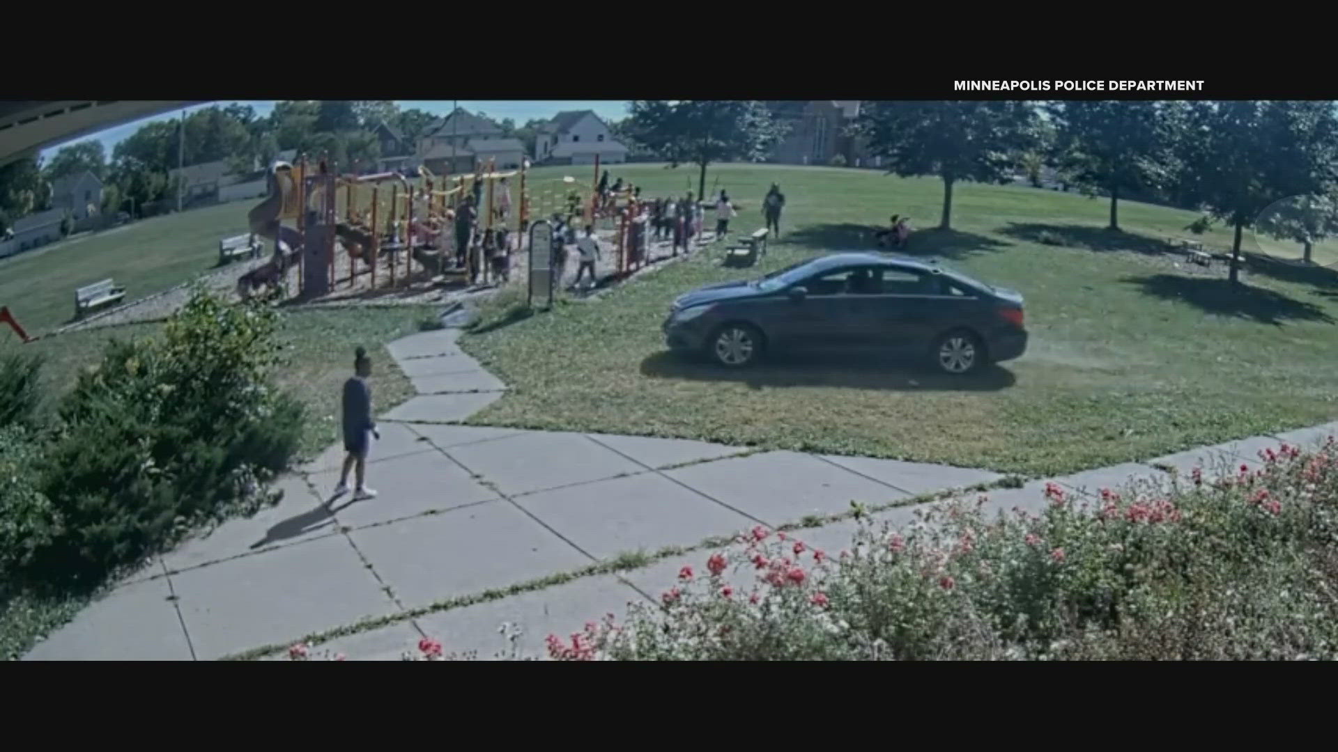 Surveillance video shows the car driving on the grass and sidewalk close to a busy playground.