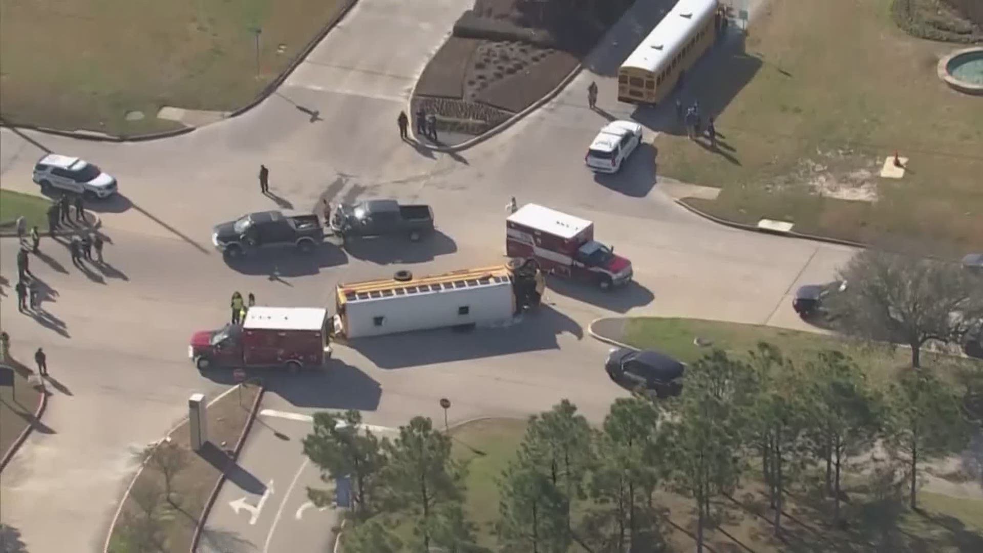 A bus filled with students flips to its side after a crash involving a pick-up truck. Some Good Samaritans helped to rescue students off the bus.