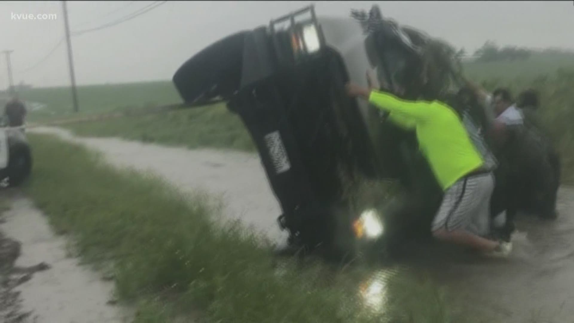 Strangers helped rescue a man from a flipped truck in a flooded ditch in Williamson County.