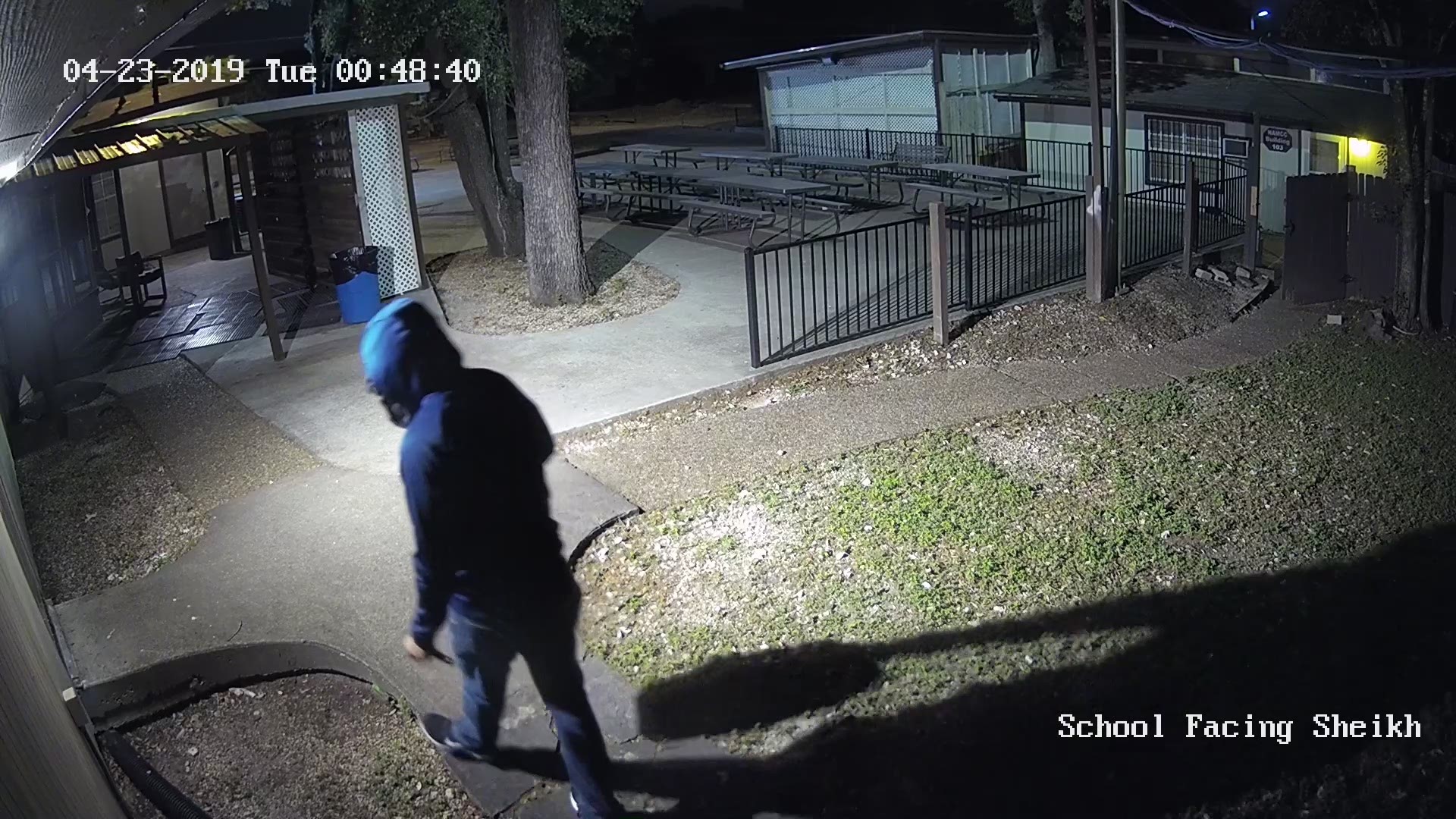 Security footage shows a man pouring liquid on a fence at the North Austin Muslim Community Center.