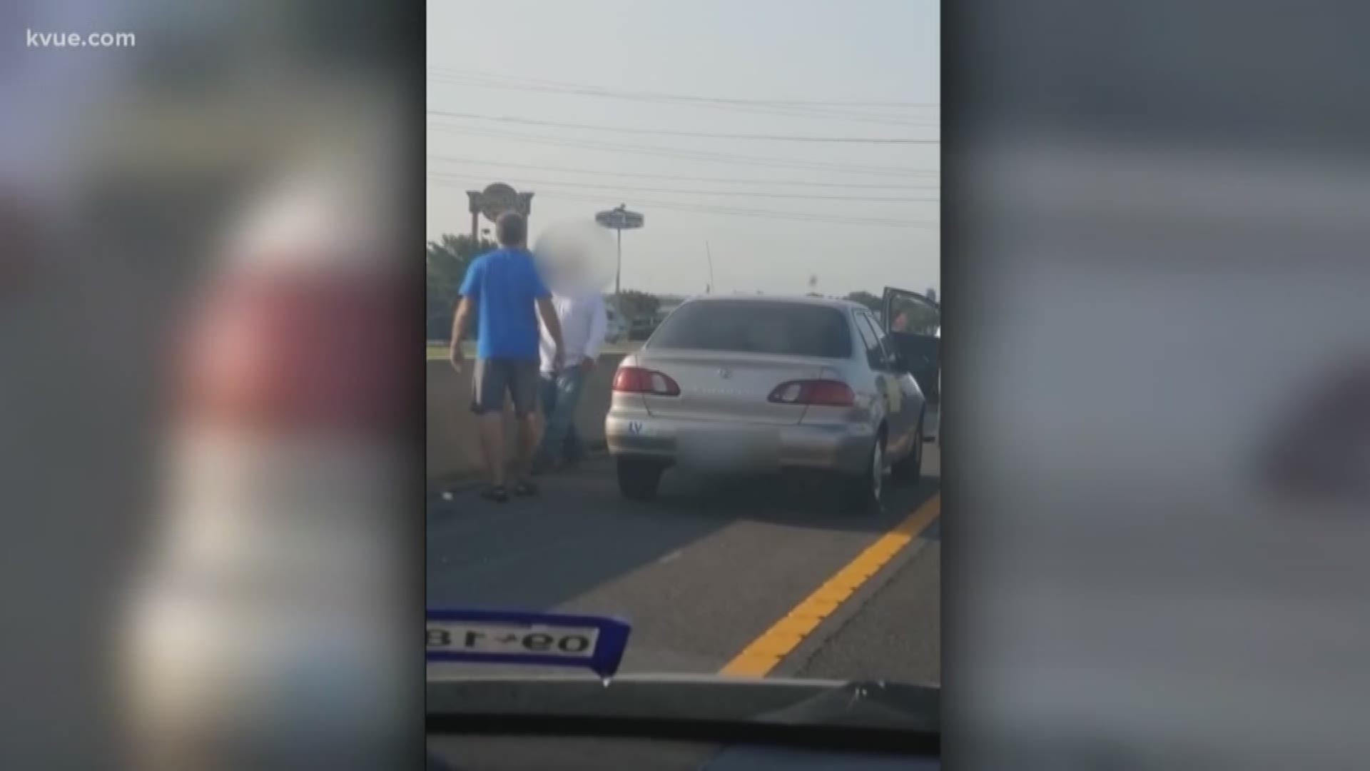 Two men were caught fighting alongside I-35 in Round Rock. A passing driver caught it all on tape.