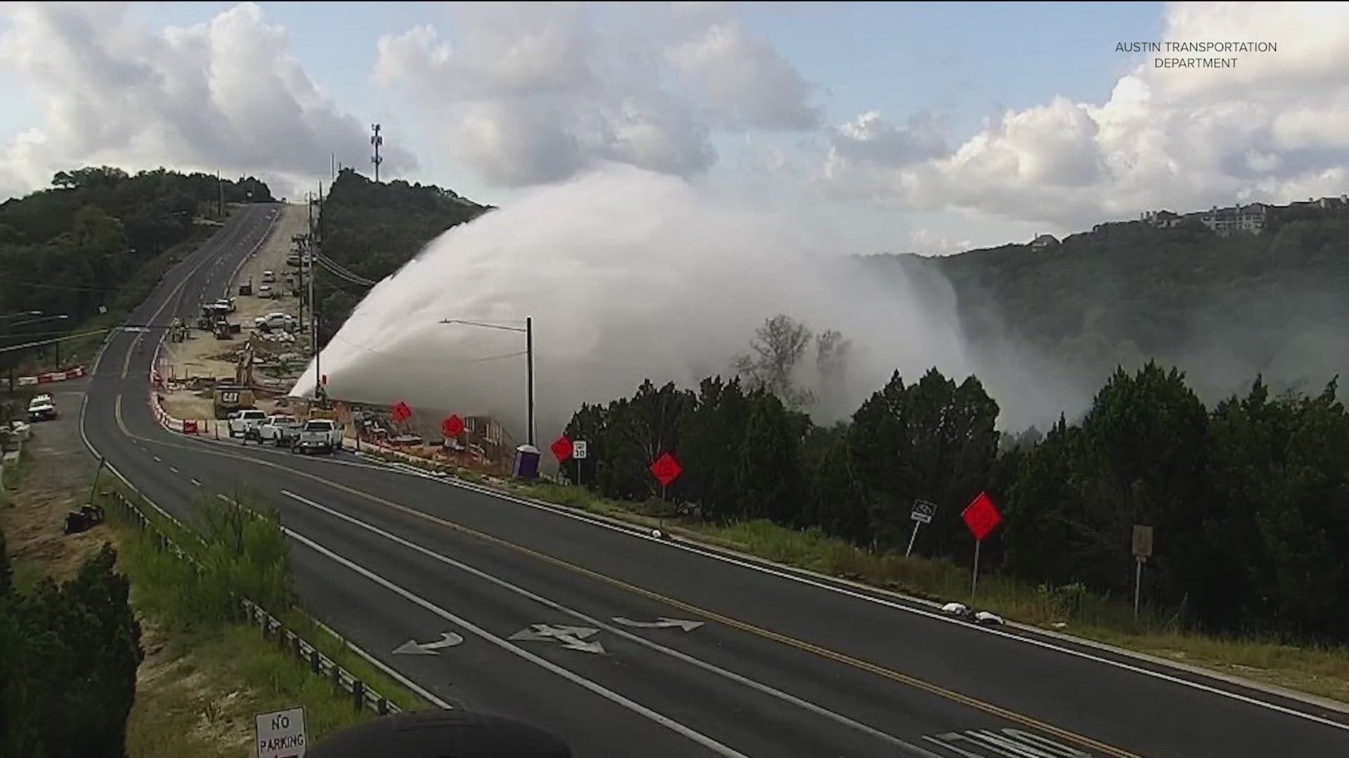 Crews shut down Spicewood Springs Road in northwest Austin Monday after a main break sent water spraying into the air.