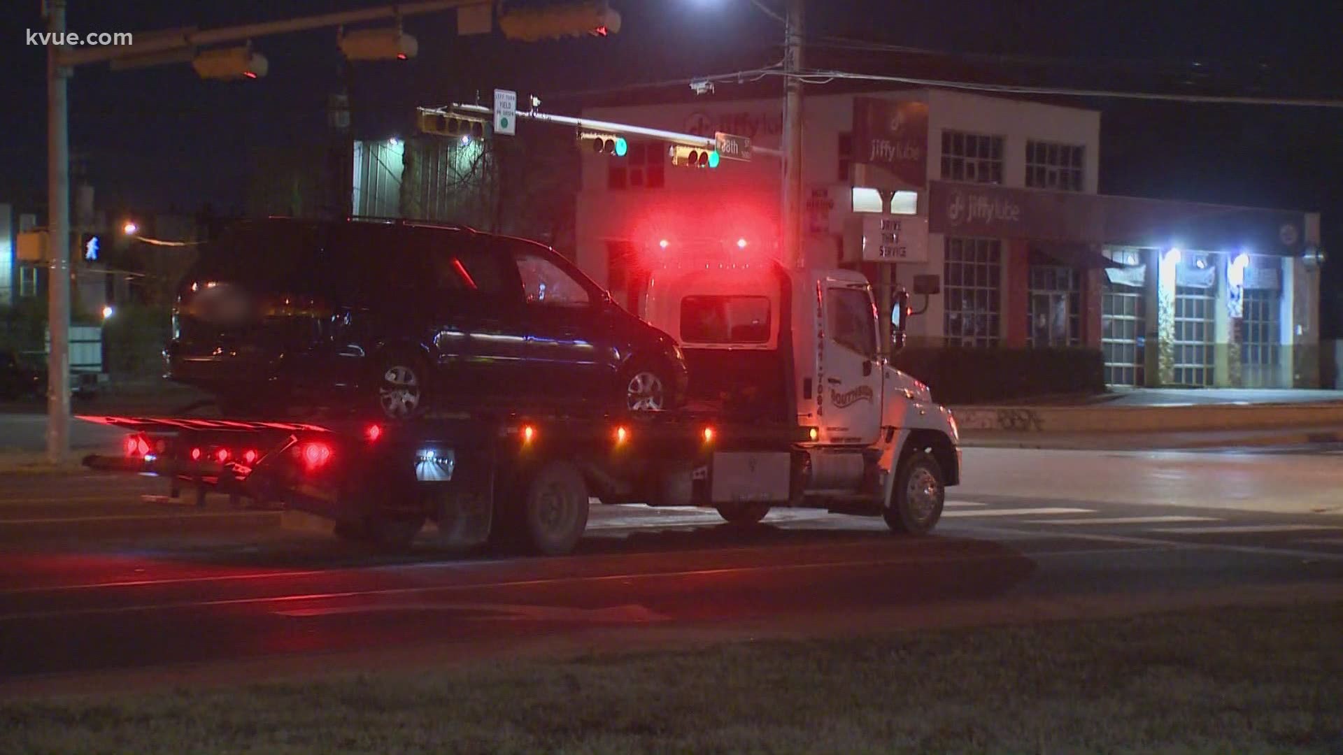 A woman is in custody after she barricaded herself in a vehicle after reportedly chasing a security guard with a knife in Downtown Austin.