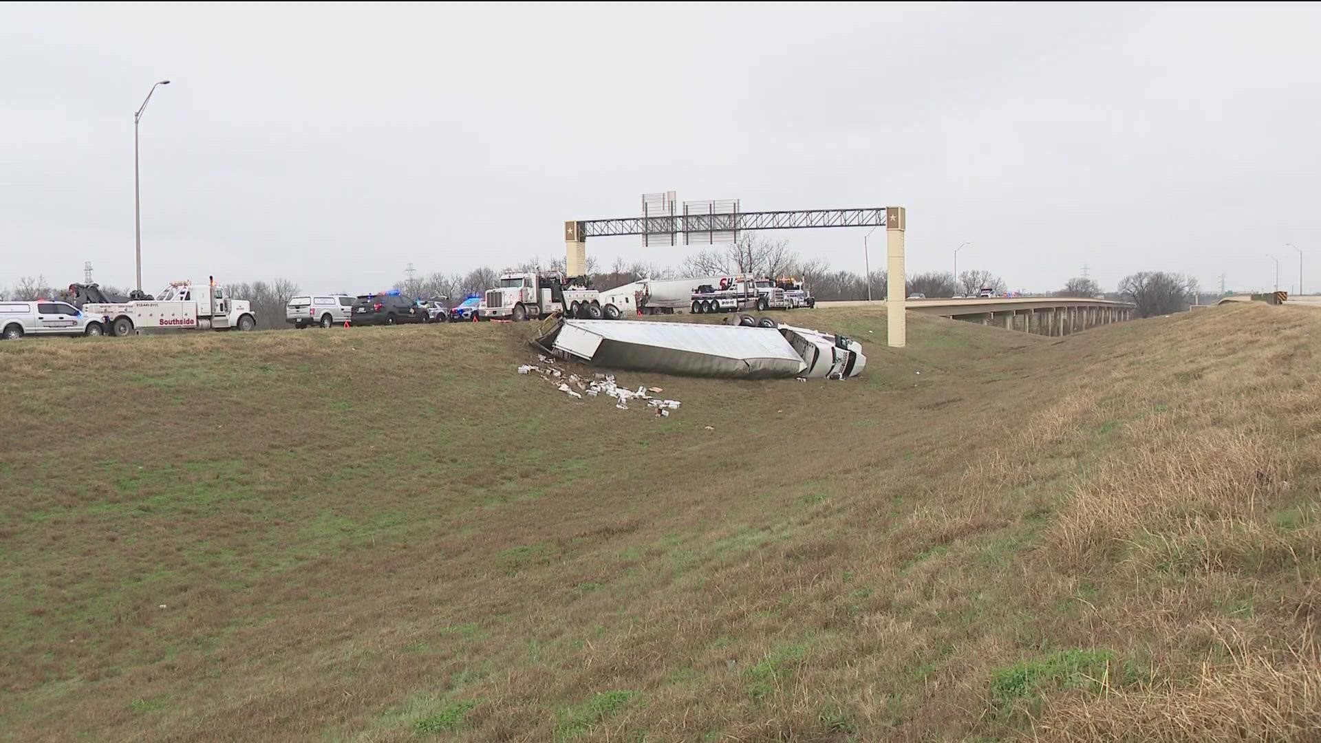 A deputy is undergoing surgery after being pinned under the tire of an 18-wheeler that lost control because of slick conditions.