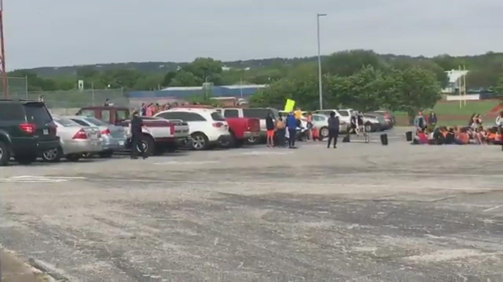McCallum High School students walk out of class and gather in the parking lot for a rally against gun violence and for more gun restrictions.