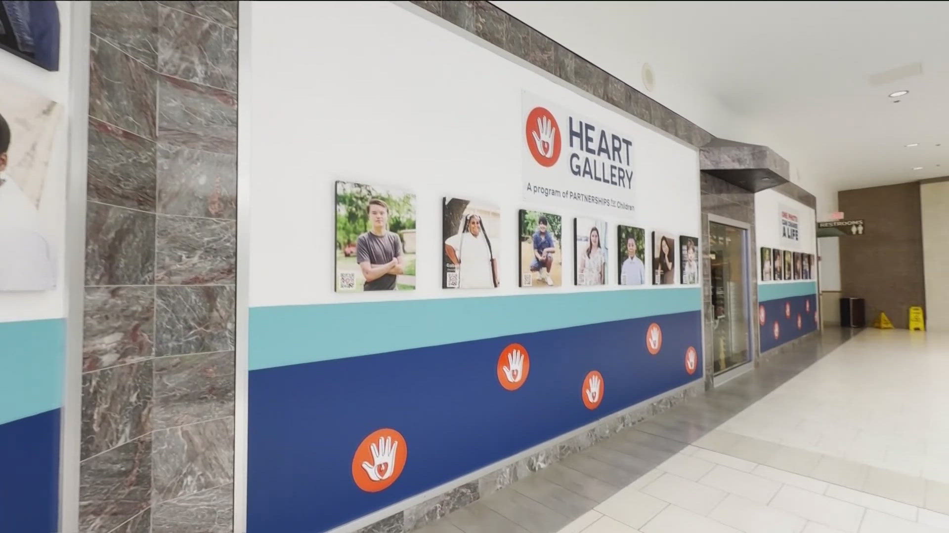 A new gallery at Lakeline Mall in Cedar Park features QR codes that can be scanned to read a child's profile and learn more about their stories.