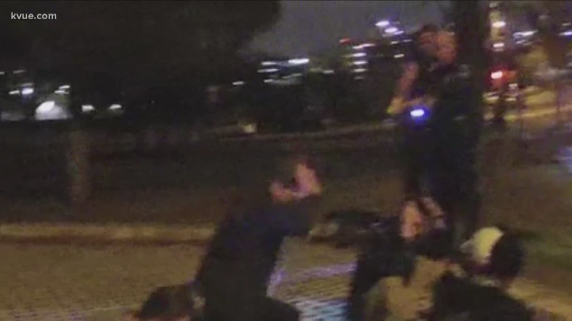 The video shows a man on his knees with his hands in the air as an Austin police officer Tased him.