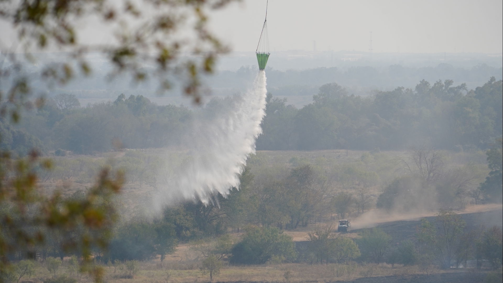 Officials said a school, neighborhood and jail were all threatened by the shifting fire at one point.