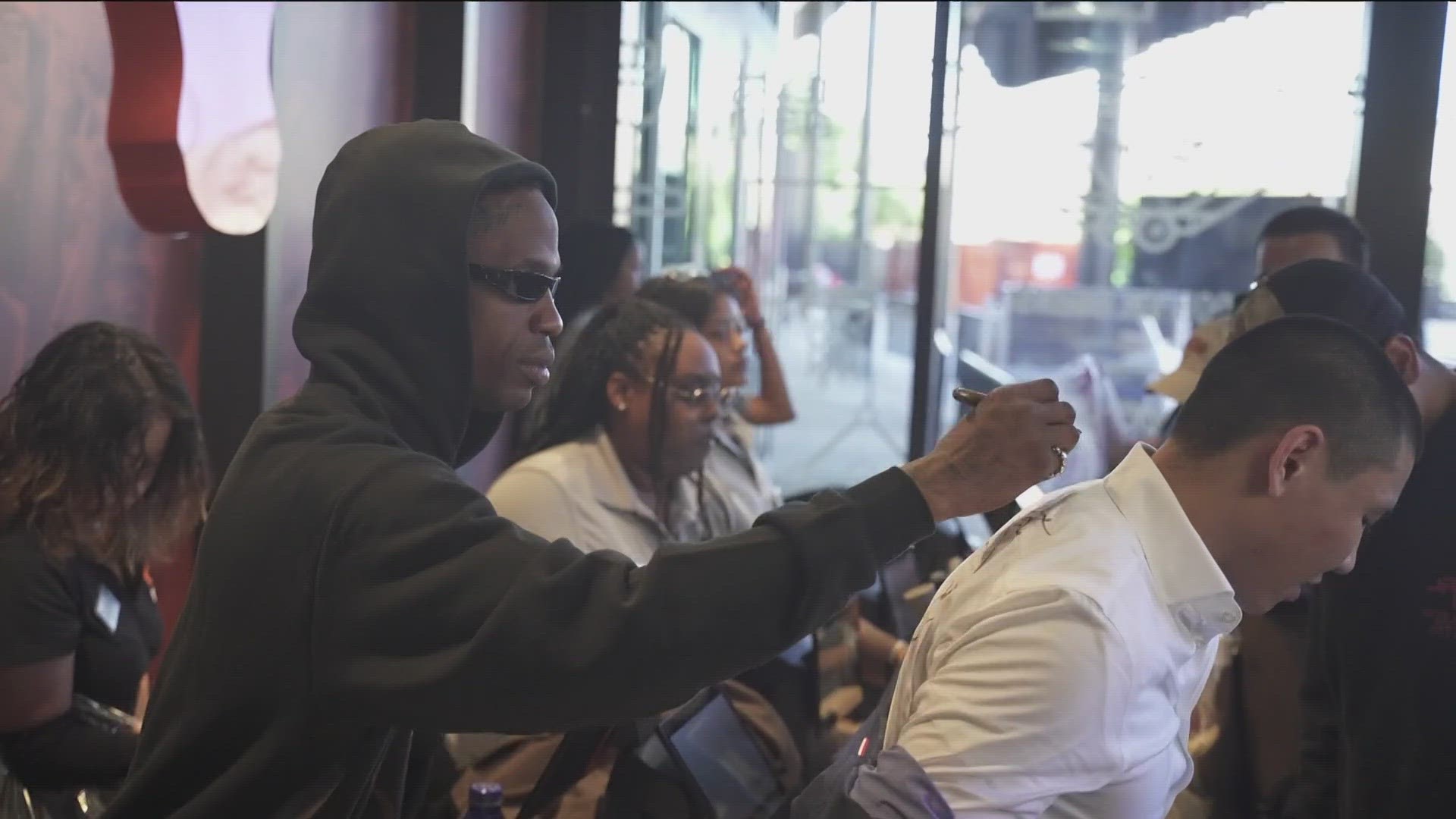 The rapper from Houston made a stop in Austin on Thursday, and was greeted by thousands of fans as he surprised the UT football team with a merchandise from the line