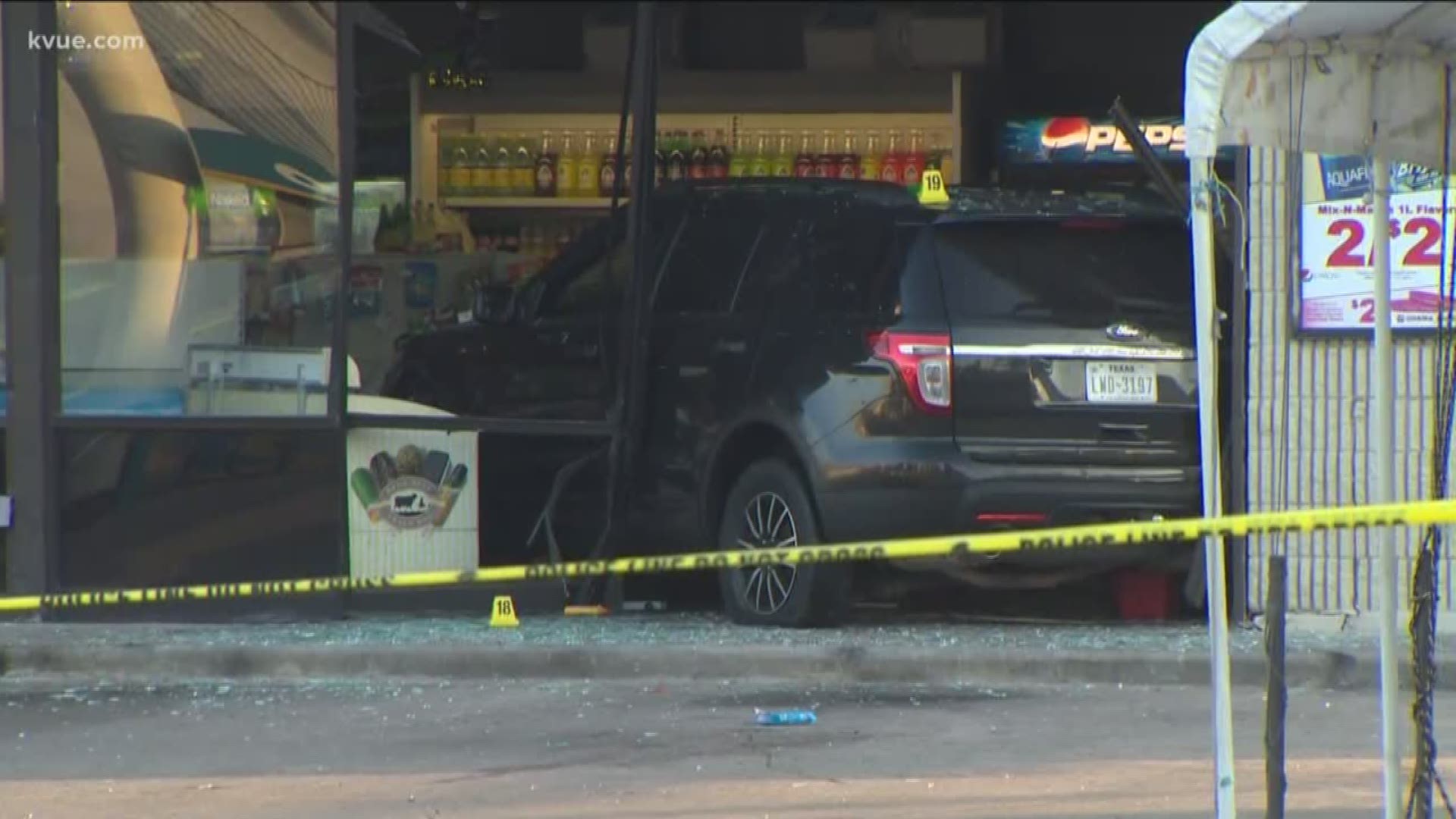 In an effort to get away, the woman drove into the convenience store, police said.