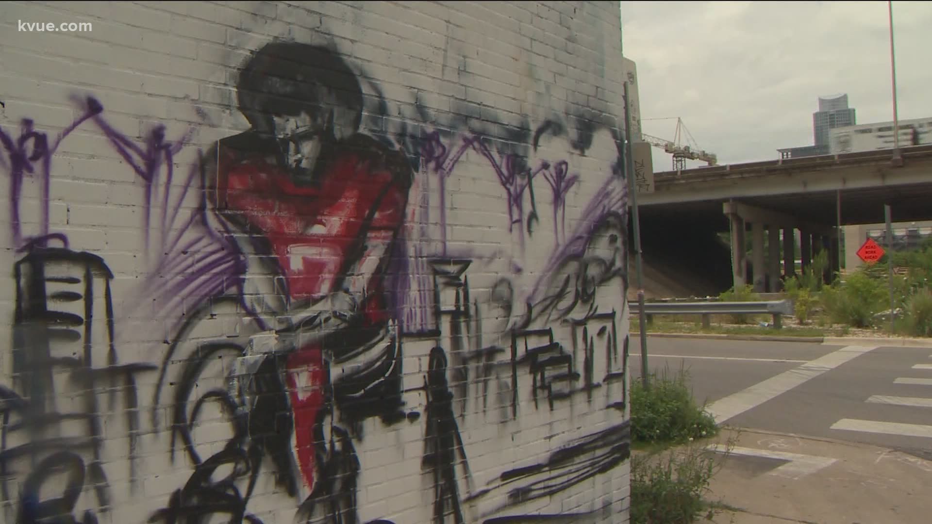 Chris Rogers is working on a mural outside Native Hostel in East Austin. The artwork is dedicated to victims of police brutality.