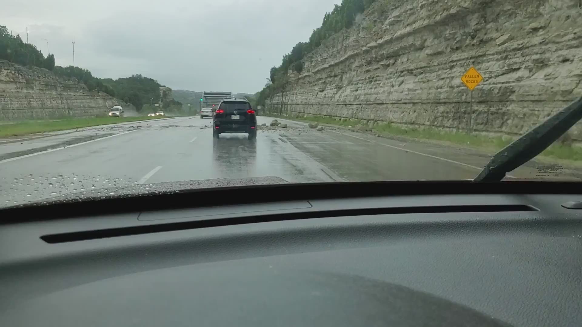 Rocks fell onto the lanes of 360 Capital of Texas Highway at Courtyard Drive southbound on Wednesday after heavy rains. Video courtesy of KVUE viewer Faith Ward.