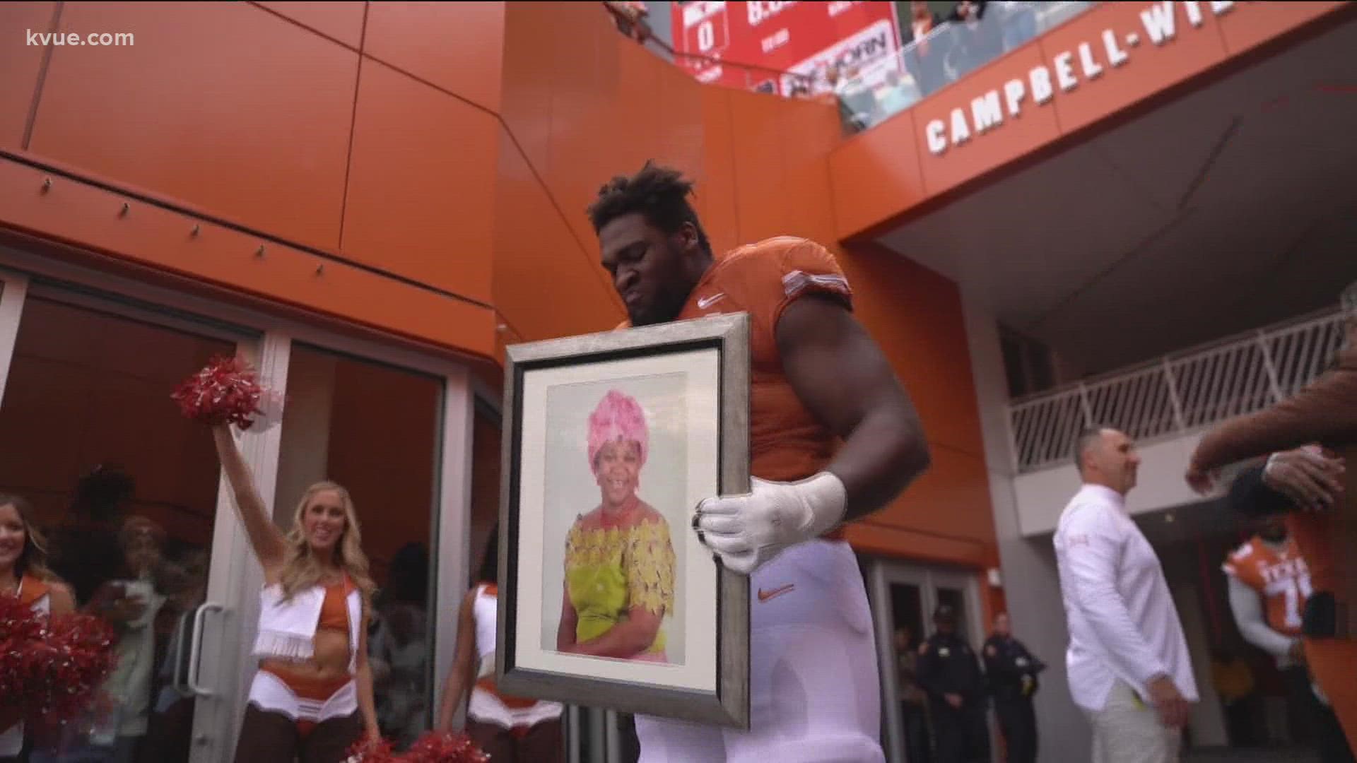 Tope Imade ran out on UT's senior night holding a picture of his mom, Betty.