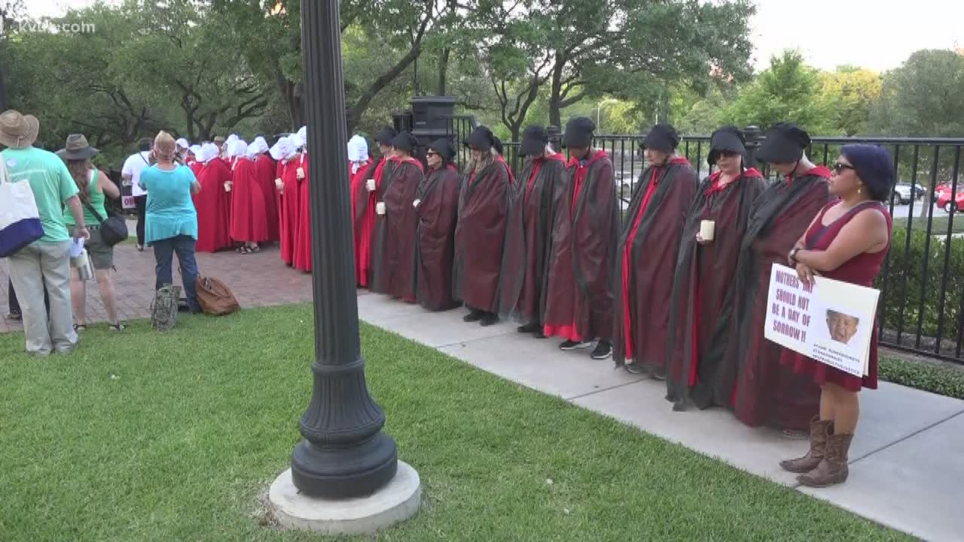 A group of women dressed as handmaids put on a protest at the Governor's Mansion to show opposition to Governor Abbott's inaction to the high maternal mortality rate in Texas.