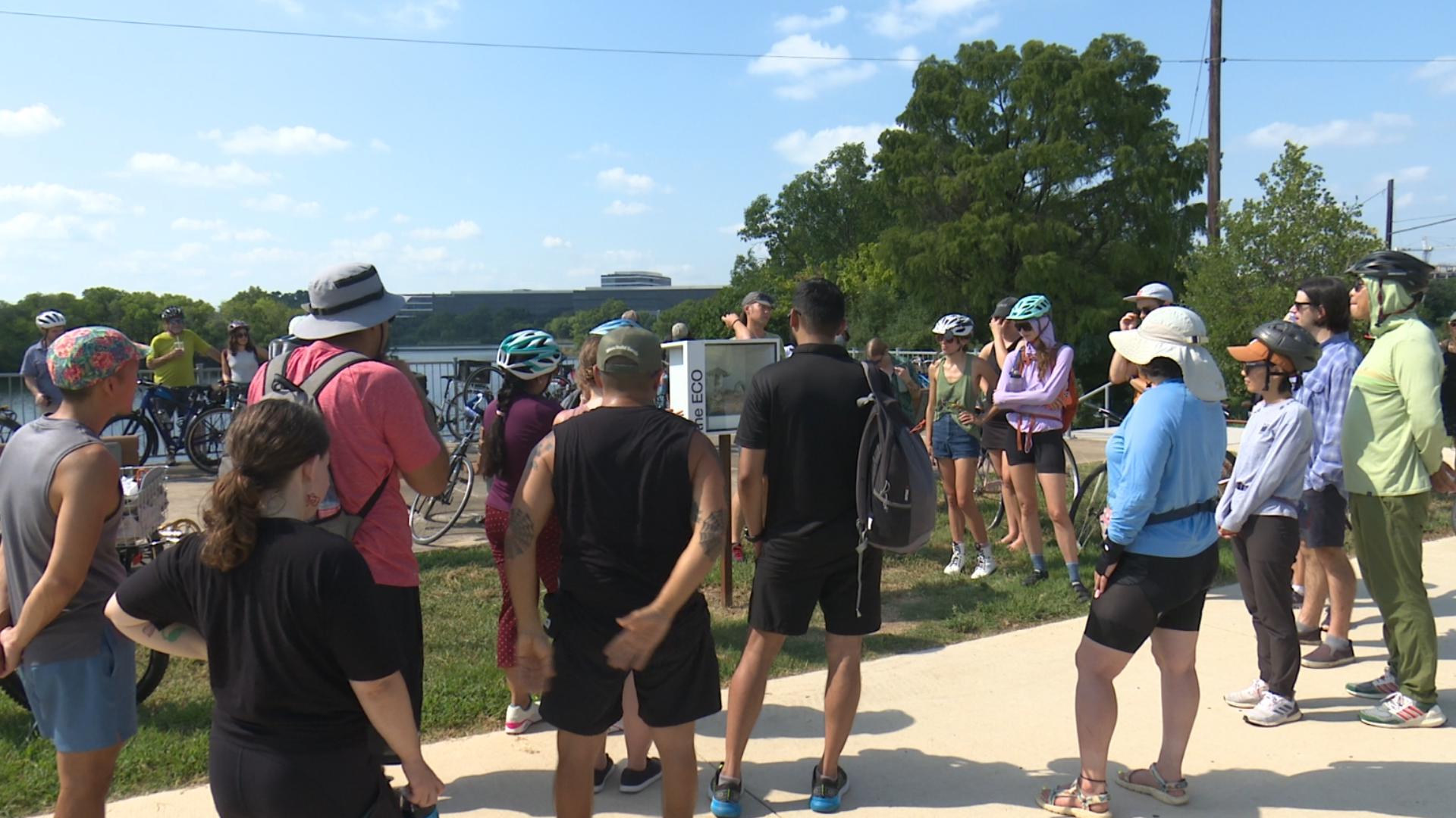 Dozens of Austinites beat the heat on two wheels Sunday to check out recently installed temporary art exhibits along Lady Bird Lake.