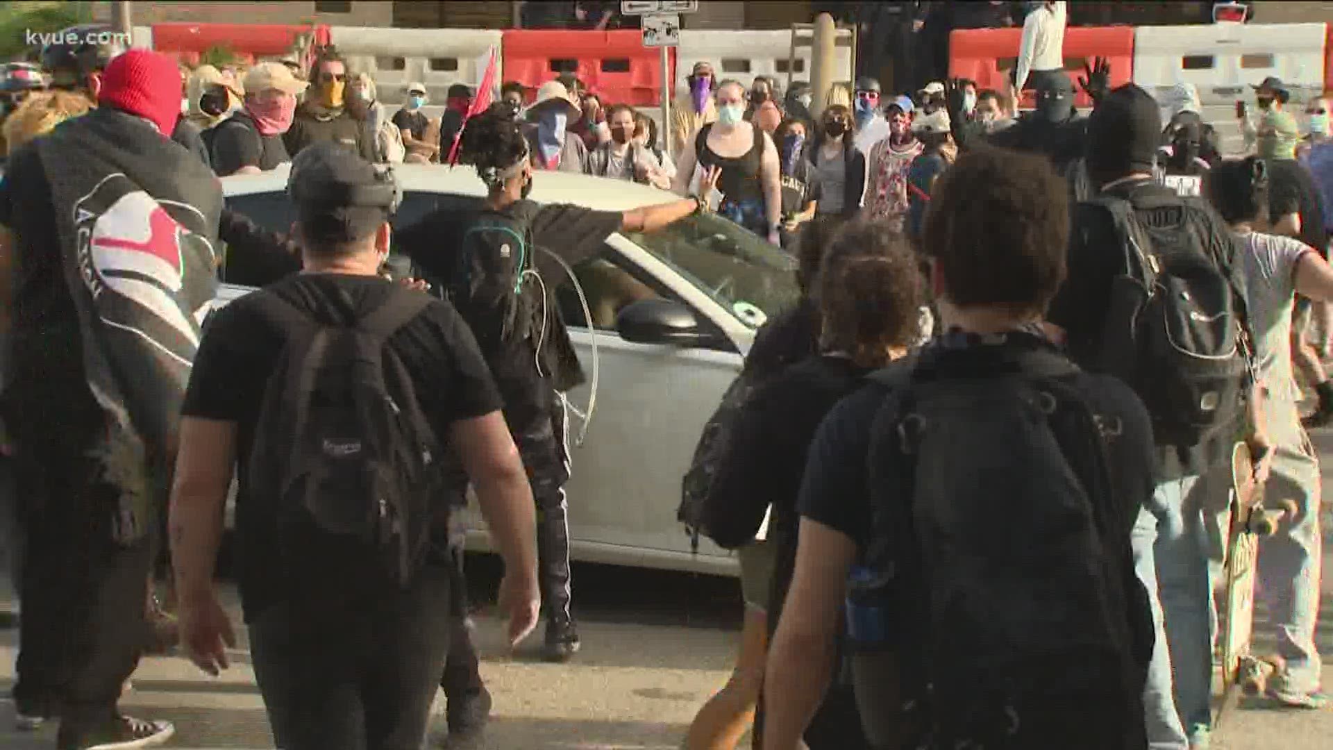 Protests calling for racial equality got a little tense after a driver pulled up in a car and possibly pointed what appeared to be a gun at the crowd.
