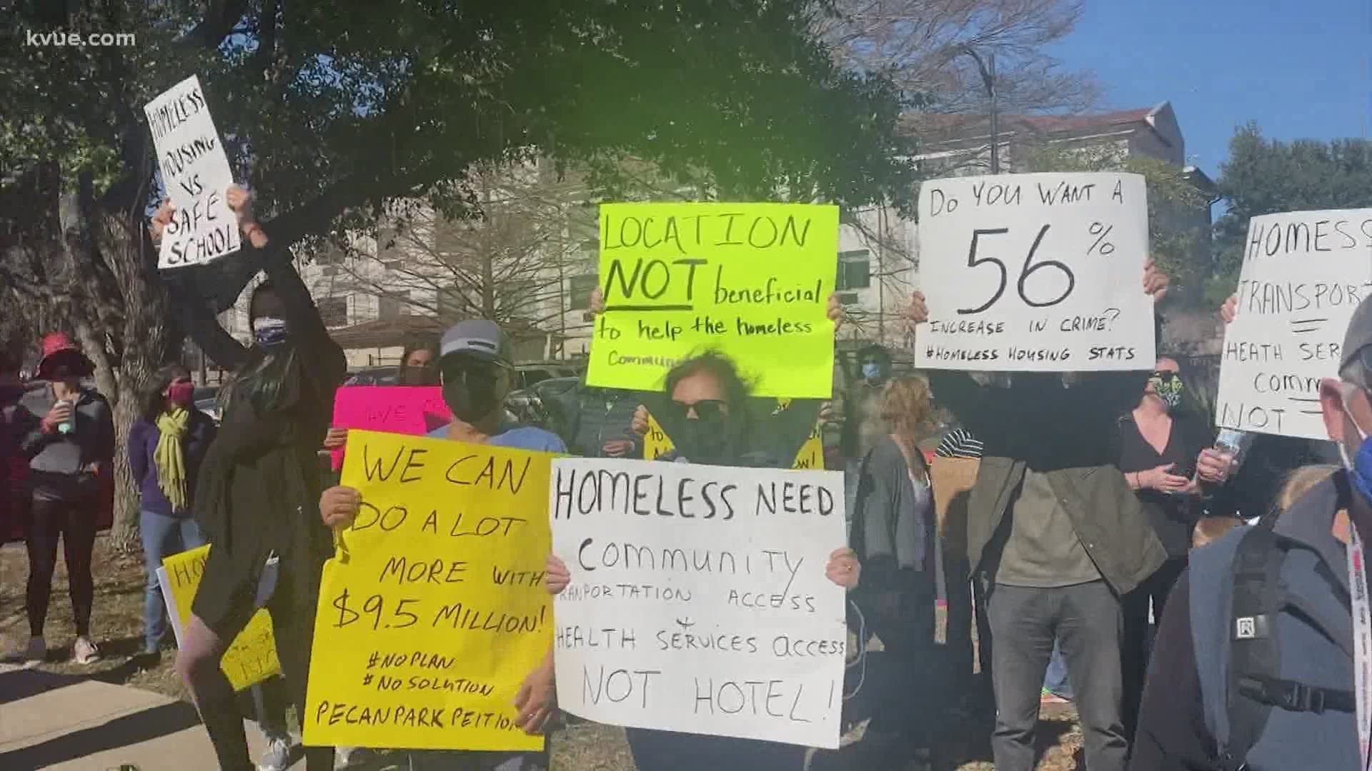 A crowd of protestors gathered outside of a Candlewood Suites hotel which Austin City Council will vote on to potentially purchase.
