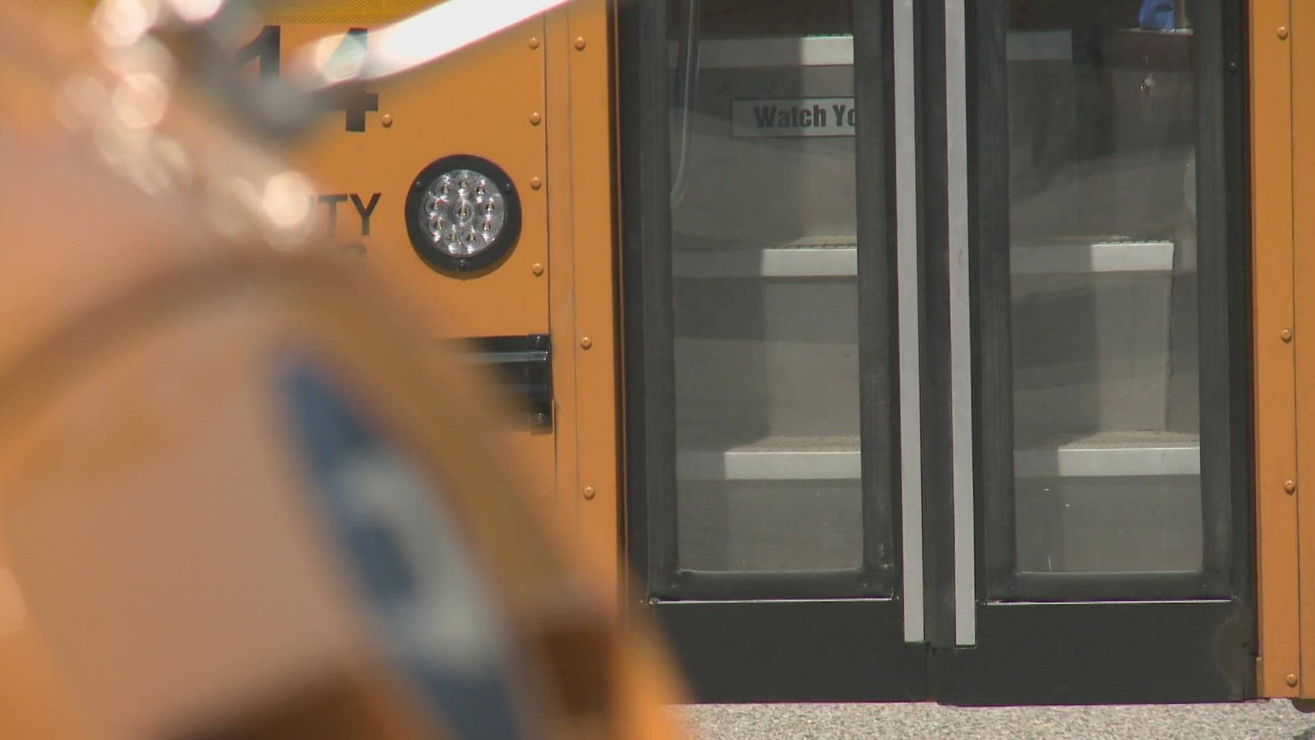 The boy's mother ran after the bus when she noticed her son caught in the door.