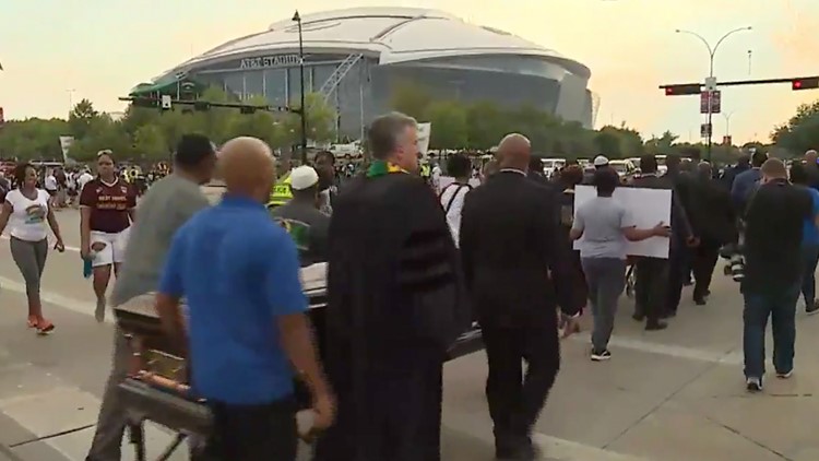 Carrying coffins, demanding justice: protesters rally for Botham Jean before Cowboys game