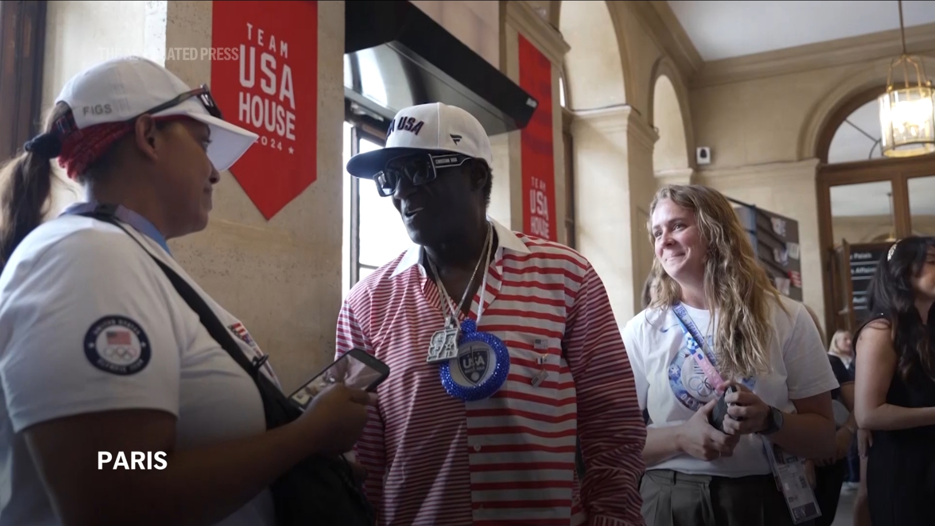 Flava Flav stopped for hugs, handshakes and high-fives as he made his way around the Team USA House at the Paris Games on Thursday.